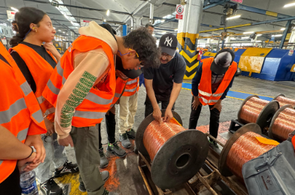 IECD students learning about the cable production process from a Nexans Morocco employee